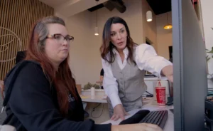 A dental consultant training a dental front office team member