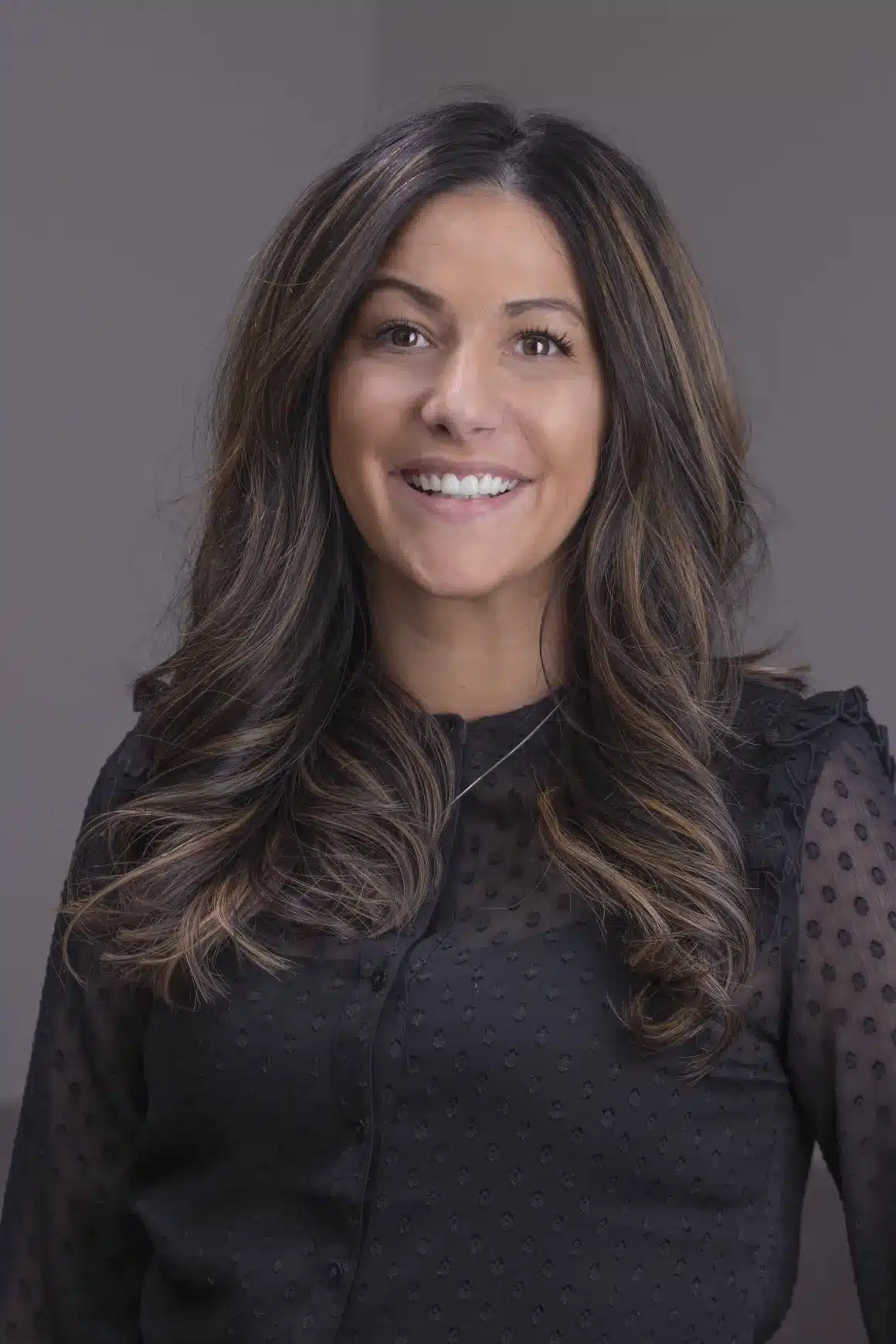 stafani posing for a headshot, stafani is an expert in dental front office coaching