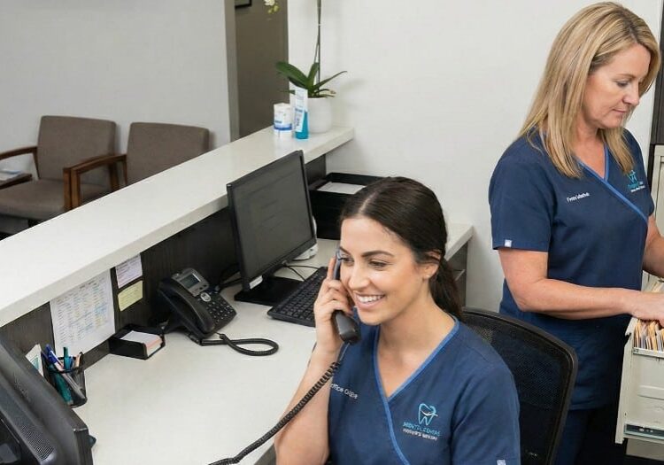 two front office admin in a dental office working together